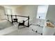 Upstairs hall with two chairs and a railing at 13706 Werrington Dr, Winter Garden, FL 34787