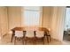 Bright dining area with a wood table and six cushioned chairs at 13706 Werrington Dr, Winter Garden, FL 34787