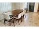 Modern dining room features a wood table with six light beige chairs at 13706 Werrington Dr, Winter Garden, FL 34787