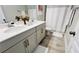 Clean bathroom with double vanity, neutral color palette and a shower/tub combo at 13706 Werrington Dr, Winter Garden, FL 34787