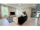Spacious living area with white couch, black cabinet, and black and white rug at 13706 Werrington Dr, Winter Garden, FL 34787