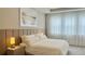 Primary bedroom featuring a king bed, neutral tones, and sheer curtains at 13706 Werrington Dr, Winter Garden, FL 34787