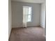 Small carpeted bedroom with a window at 1523 Wynford Cir, Tavares, FL 32778