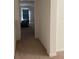 Carpeted hallway with view into a bedroom at 1523 Wynford Cir, Tavares, FL 32778