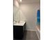 Clean bathroom with dark vanity and grey wood-look floors at 1523 Wynford Cir, Tavares, FL 32778
