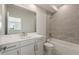 Bathroom with tiled shower/tub, white vanity and mirror at 107 Hampton Loop, Davenport, FL 33837