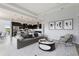 Open living room with gray sofa and view into kitchen area at 107 Hampton Loop, Davenport, FL 33837