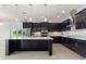 Contemporary kitchen featuring dark cabinetry and a spacious island at 107 Hampton Loop, Davenport, FL 33837
