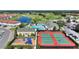 Aerial view showing community pool, tennis courts, playground, and clubhouse at 107 Hampton Loop, Davenport, FL 33837