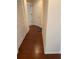 Well-lit hallway with rich hardwood floors and neutral wall tones at 11774 Via Lucerna Cir, Windermere, FL 34786