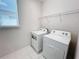 Convenient laundry room with washer, dryer, and ample shelving at 1612 Herrons Green Path, Kissimmee, FL 34747