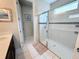 Bathroom with walk-in shower, tile flooring, and modern vanity at 1612 Herrons Green Path, Kissimmee, FL 34747