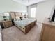 Comfortable bedroom with a king-size bed and neutral decor at 1612 Herrons Green Path, Kissimmee, FL 34747