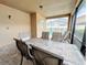 Relaxing screened patio with table and chairs, overlooking the pool at 1612 Herrons Green Path, Kissimmee, FL 34747