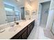 Primary bathroom with double vanity and a walk-in shower at 1612 Herrons Green Path, Kissimmee, FL 34747