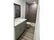 Stylish bathroom featuring a double vanity, walk-in shower, and tiled walls at 649 Lincoln St, Kissimmee, FL 34741