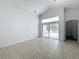 Living room featuring tile floors and access to backyard patio at 744 Stonewyk Way, Kissimmee, FL 34744