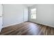 Well-lit bedroom featuring wood-look floors at 744 Stonewyk Way, Kissimmee, FL 34744