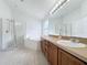 Main bathroom with double sinks, shower, and soaking tub at 744 Stonewyk Way, Kissimmee, FL 34744