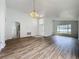 Open living room showcasing wood-look floors and a view into kitchen at 744 Stonewyk Way, Kissimmee, FL 34744