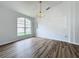 Light-filled dining area with a large window and elegant chandelier at 744 Stonewyk Way, Kissimmee, FL 34744