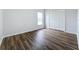 Bedroom with wood-look floors, window, and double doors at 744 Stonewyk Way, Kissimmee, FL 34744