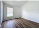 Bright bedroom with wood-look flooring and window at 744 Stonewyk Way, Kissimmee, FL 34744