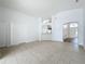 Open living area with tile flooring, a view into the kitchen and entryway at 744 Stonewyk Way, Kissimmee, FL 34744