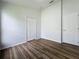 Spacious bedroom with wood-look flooring and two closets at 744 Stonewyk Way, Kissimmee, FL 34744