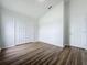 Spacious bedroom with double doors and wood-look floors at 744 Stonewyk Way, Kissimmee, FL 34744