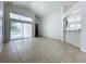 Living room with tile floors, sliding doors to patio, and high ceilings at 744 Stonewyk Way, Kissimmee, FL 34744