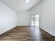 Bright bedroom featuring wood-look floors and access to backyard at 744 Stonewyk Way, Kissimmee, FL 34744