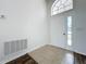 Bright entryway with tile flooring, a white door, and an arched window at 744 Stonewyk Way, Kissimmee, FL 34744