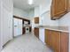 Kitchen with wood cabinets, white appliances, and tile flooring at 744 Stonewyk Way, Kissimmee, FL 34744