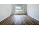Bright living room with wood-look flooring and an arched window at 744 Stonewyk Way, Kissimmee, FL 34744