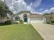 House exterior with teal door and attached garage at 744 Stonewyk Way, Kissimmee, FL 34744