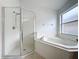 Bathroom boasts a shower, corner tub, and updated vanity at 744 Stonewyk Way, Kissimmee, FL 34744