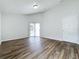 Bedroom with wood-look floors, door to bathroom and sliding glass doors at 744 Stonewyk Way, Kissimmee, FL 34744
