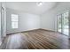 Spacious bedroom with wood-look flooring and sliding glass doors to patio at 744 Stonewyk Way, Kissimmee, FL 34744