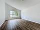 Spacious living room featuring wood-look flooring and a large window at 744 Stonewyk Way, Kissimmee, FL 34744