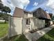 Townhouse with brown roof, gated entrance, and landscaped yard at 4009 Shannon Brown Dr, Orlando, FL 32808