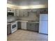 Modern kitchen with gray cabinets and stainless steel appliances at 4009 Shannon Brown Dr, Orlando, FL 32808