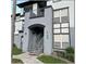 Exterior view of a two-story building with stairs and landscaping at 3701 Castle Pines Ln # 3914, Orlando, FL 32839