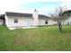 Home exterior showcasing a patio and grassy yard at 348 Jacksonville Ct, Kissimmee, FL 34759