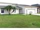 House exterior with a one car garage and grassy yard at 348 Jacksonville Ct, Kissimmee, FL 34759