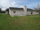 Home exterior showcasing a patio and grassy yard at 348 Jacksonville Ct, Kissimmee, FL 34759