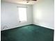 Green carpeted bedroom with a window and ceiling fan at 348 Jacksonville Ct, Kissimmee, FL 34759