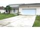 House exterior featuring a two-car garage at 348 Jacksonville Ct, Kissimmee, FL 34759