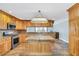 Eat-in kitchen with granite island and wood cabinets at 4147 Boggy Creek Rd, Kissimmee, FL 34744