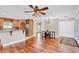 Hardwood floors, high ceilings, and a ceiling fan accent this bright and spacious living area at 4147 Boggy Creek Rd, Kissimmee, FL 34744